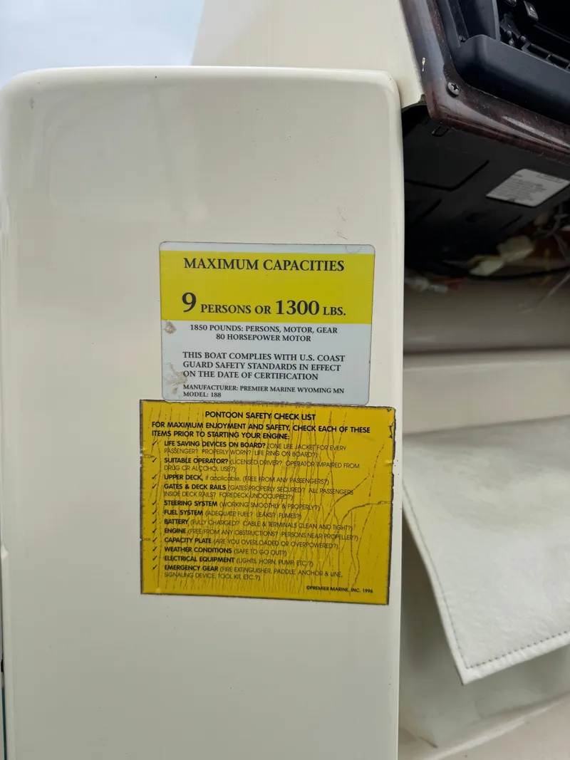 Slide: The Image of 1996 Premier Odyessea capacity label, maximum 9 persons or 1300 lbs, safety instructions visible. - 12