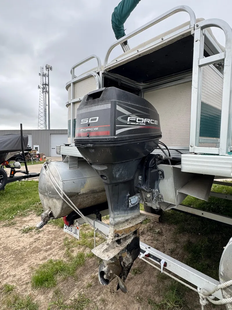 Slide: The Image of 1996 Premier Odyessea boat with Force 50 outboard motor, parked on grass. - 3