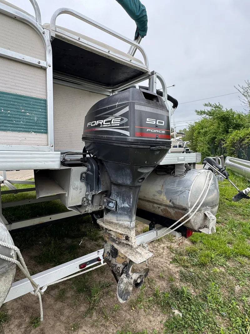 Slide: The Image of 1996 Premier Odyessea boat with Force 50 outboard motor, parked on grass. - 4
