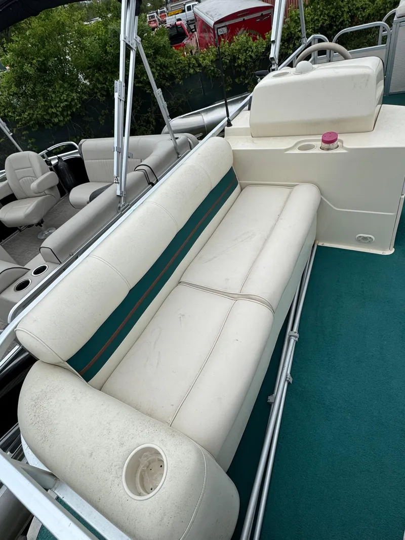 Slide: The Image of 1996 Premier Odyessea boat interior with white seating and teal accents. - 8