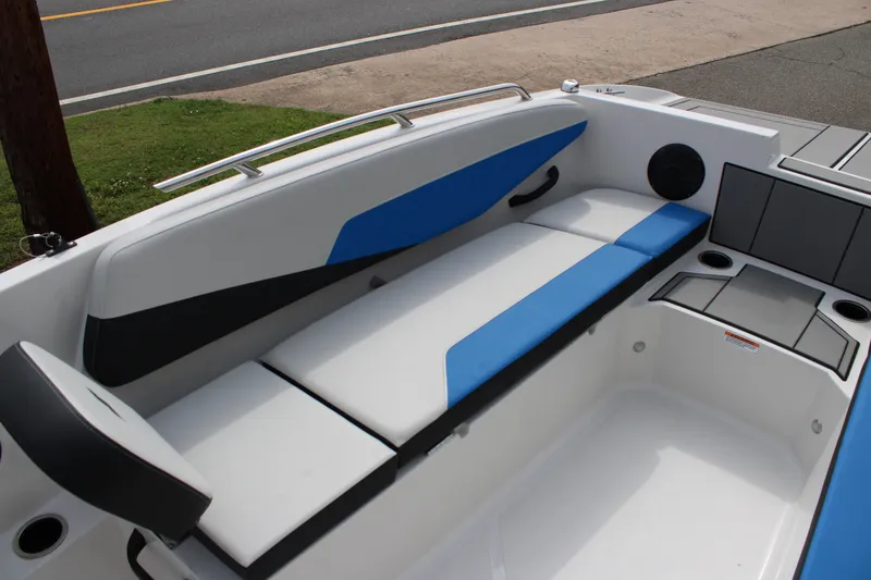 Slide: The Image of 2025 Starcraft SV 16 OB boat interior with blue and white seating, cup holders, and sleek design. - 10