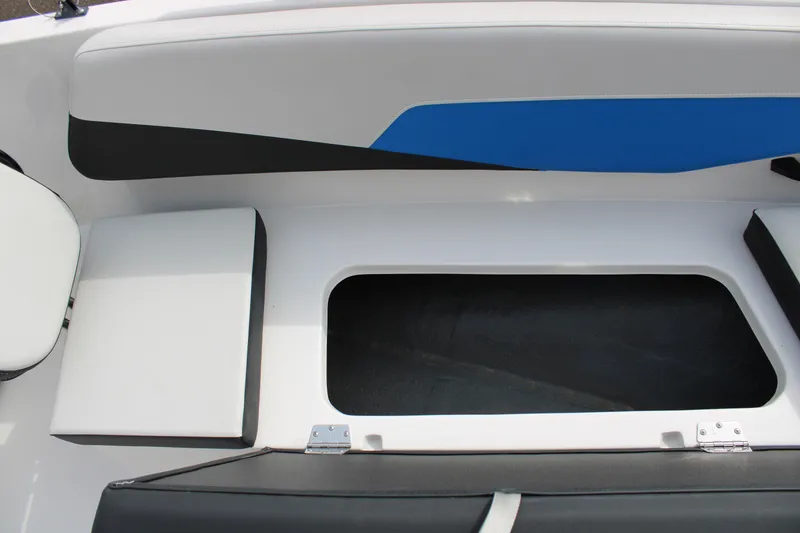 Slide: The Image of 2025 Starcraft SV 16 OB boat interior storage compartment with sleek black and blue accents. - 11