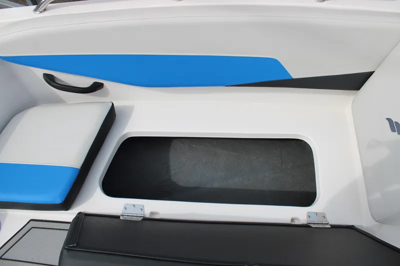 Slide: The Image of 2025 Starcraft SV 16 OB boat interior with blue accents and storage compartment. - 12
