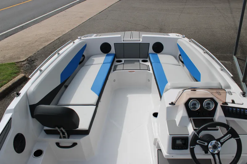Slide: The Image of 2025 Starcraft SV 16 OB boat interior with blue and white seating, steering console, and dashboard. - 6