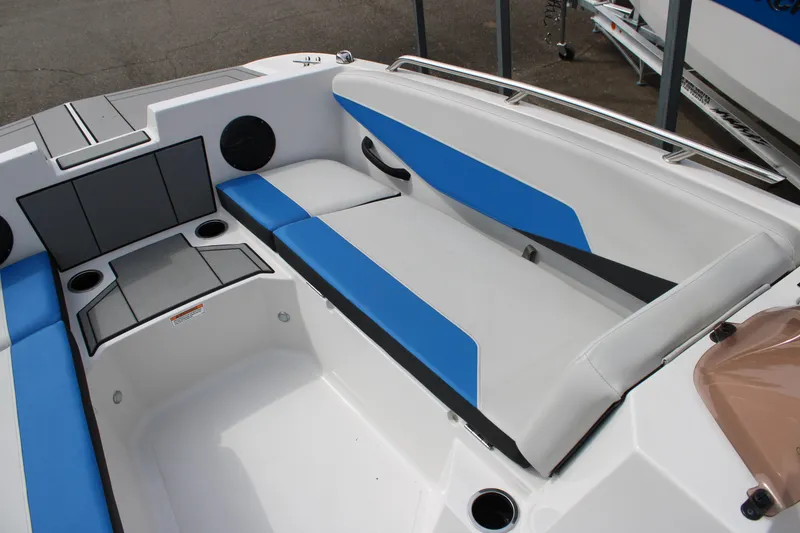 Slide: The Image of 2025 Starcraft SV 16 OB boat interior with blue and gray seating, cup holders, and speakers. - 9