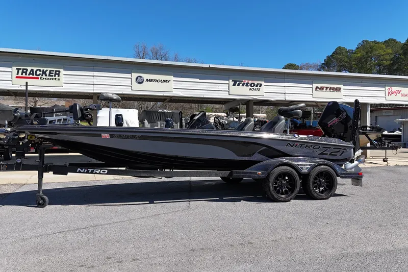 The Image of 2024 Nitro Z21 XL Pro bass boat on trailer at dealership. - 0