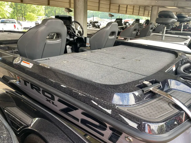 Slide: The Image of 2024 Nitro Z21 XL Pro boat, sleek design, spacious seating, under covered area. - 24