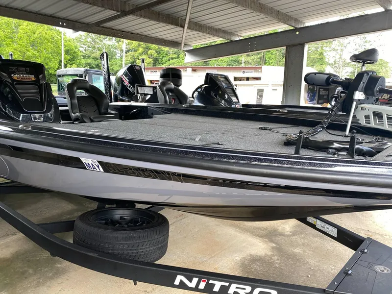 Slide: The Image of 2024 Nitro Z21 XL Pro bass boat in a covered storage area. - 4