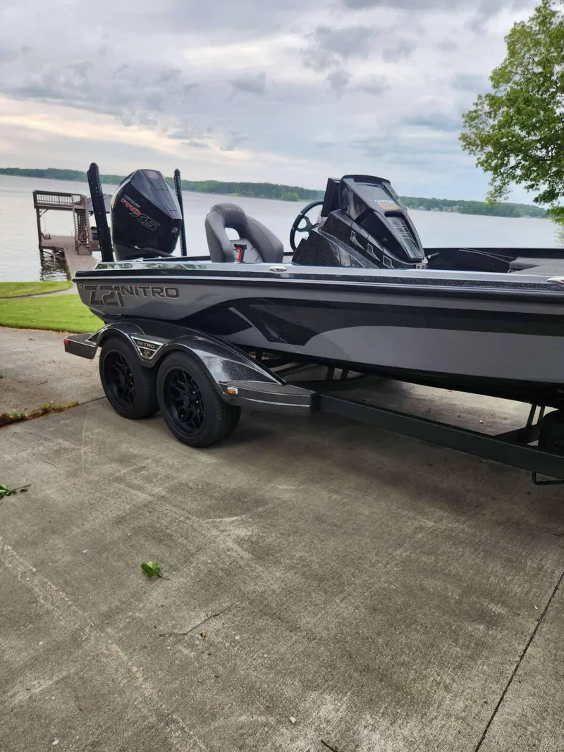 Slide: The Image of 2024 Nitro Z21 XL Pro boat on trailer by a lakeside. - 6