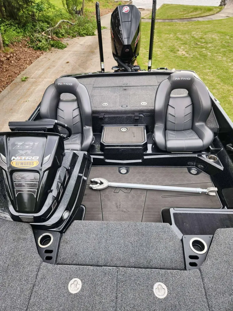 Slide: The Image of 2024 Nitro Z21 XL Pro boat interior with dual seats and motor, showcasing sleek design. - 9
