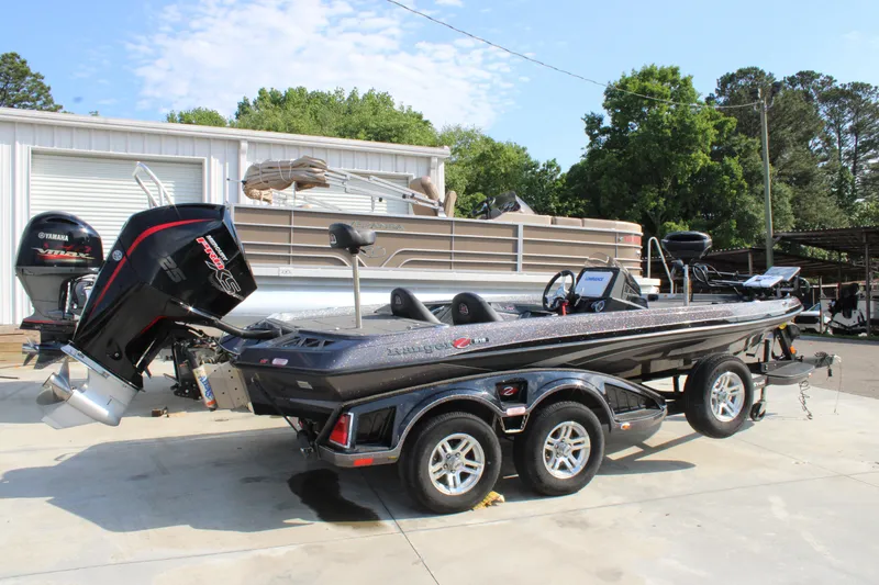 Slide: The Image of 2023 Ranger Z519 Ranger Cup Equipped boat parked outdoors, featuring a sleek design and powerful engine. - 1