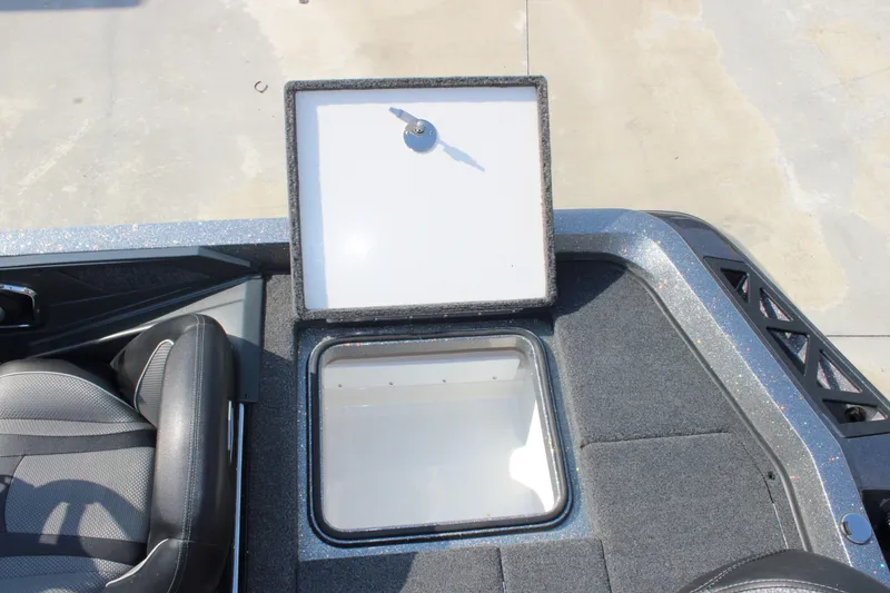 Slide: The Image of 2023 Ranger Z519 Ranger Cup Equipped boat storage compartment with open lid, showing interior space. - 23