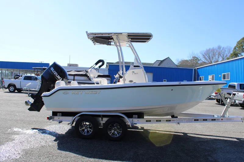 Slide: The Image of 2025 Key West 189 FS boat on trailer, parked outdoors. - 0