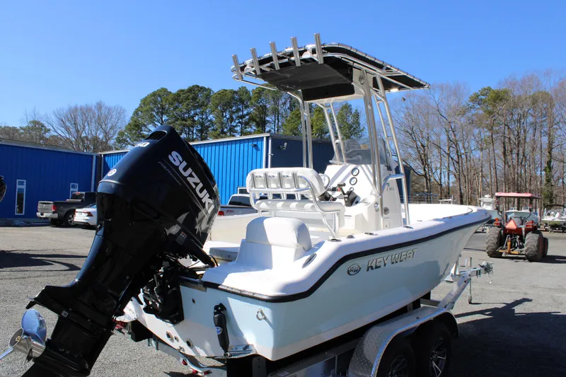 Slide: The Image of 2025 Key West 189 FS boat with Suzuki outboard motor on a trailer. - 2