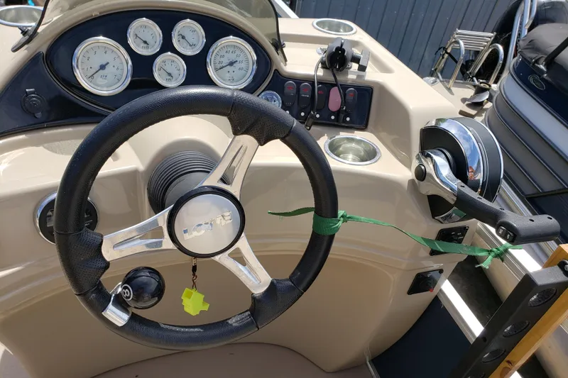 Slide: The Image of Steering console of a 2015 Lowe SF214 Sport Fish boat with gauges and controls. - 4