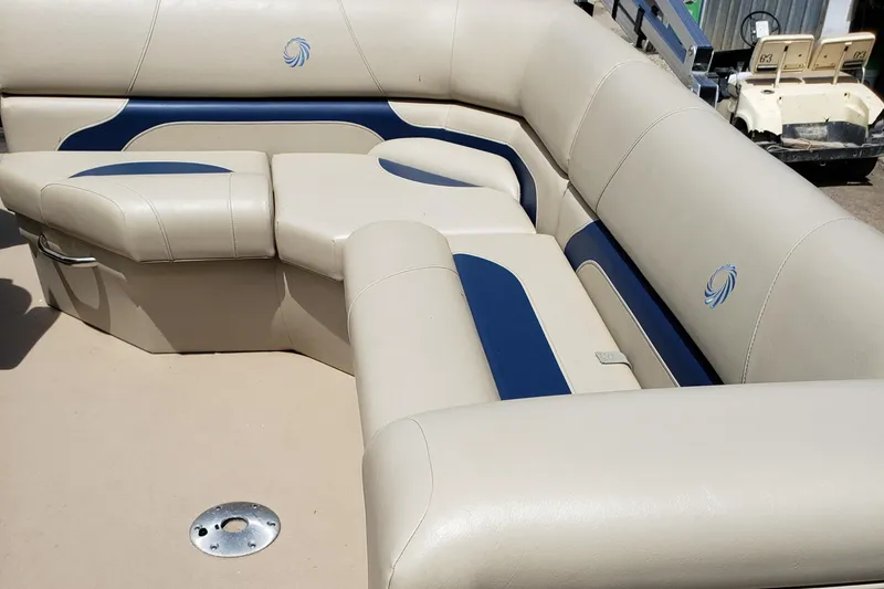 Slide: The Image of 2015 Lowe SF214 Sport Fish boat interior with beige and blue cushioned seating. - 6