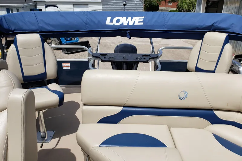 Slide: The Image of 2015 Lowe SF214 Sport Fish boat interior with beige and blue seating. - 7
