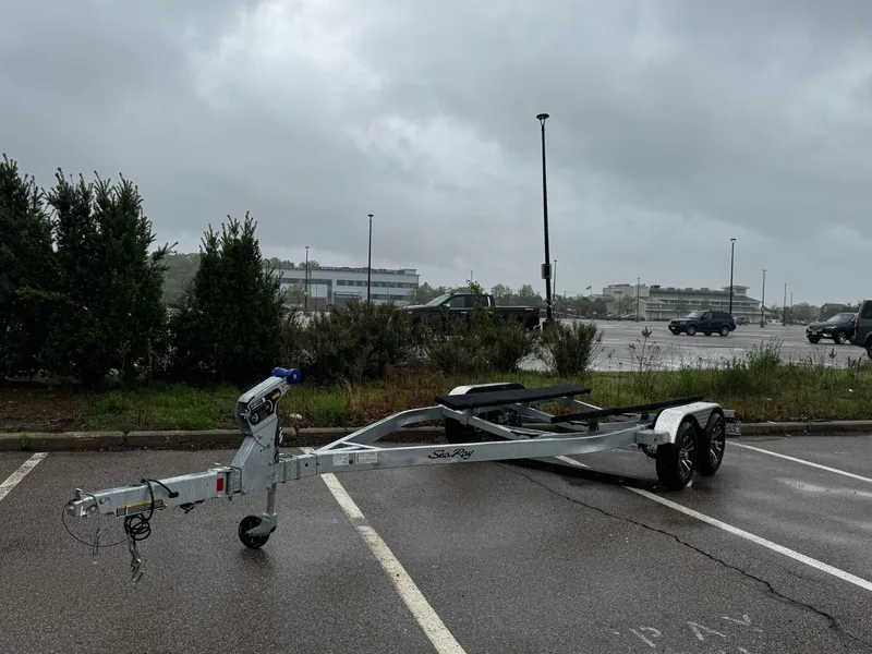 Slide: The Image of Trailer for 2023 Sea Ray SPX 210 OB in a parking lot on a cloudy day. - 3