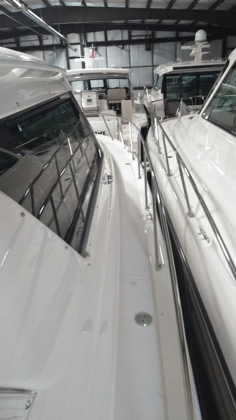 Slide: The Image of 2005 Tiara Yachts 4400 Sovran in storage, showcasing sleek design and polished railings. - 11
