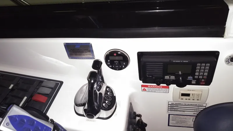 Slide: The Image of 2005 Tiara Yachts 4400 Sovran control panel with throttle and VHF radio. - 14