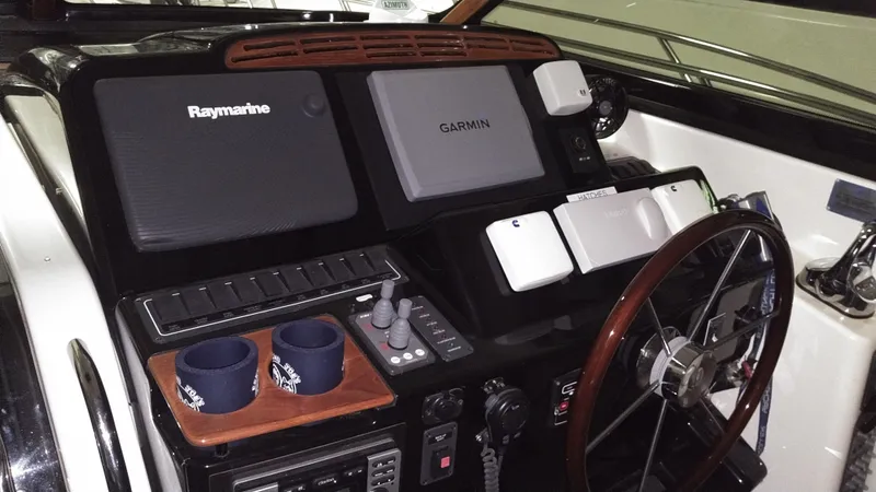 Slide: The Image of 2005 Tiara Yachts 4400 Sovran helm with Raymarine and Garmin navigation systems. - 16