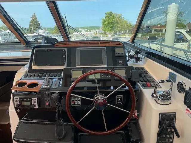 Slide: The Image of Helm of 2005 Tiara Yachts 4400 Sovran with navigation equipment and steering wheel. - 17