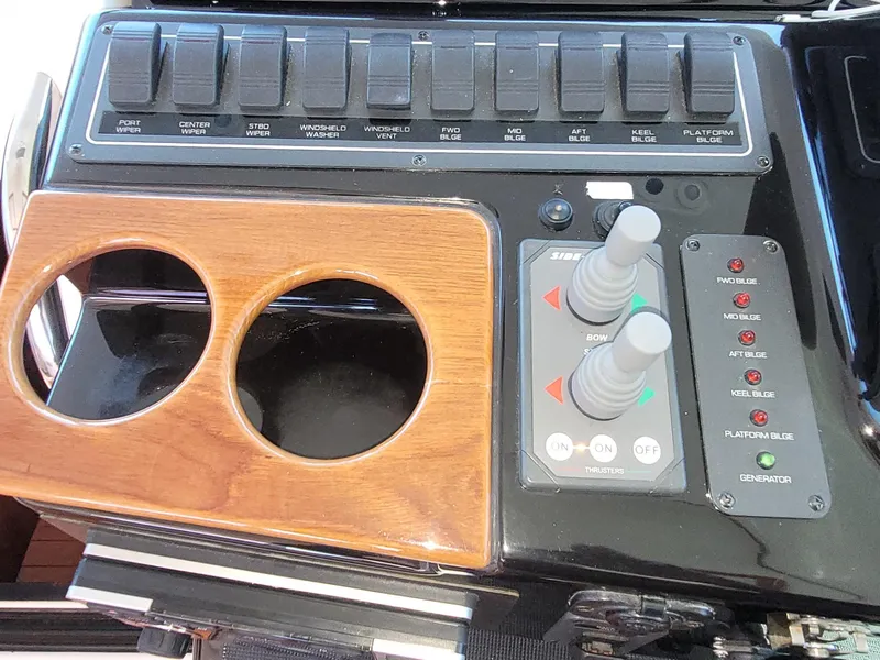 Slide: The Image of Control panel of 2005 Tiara Yachts 4400 Sovran with joystick and cup holders. - 21