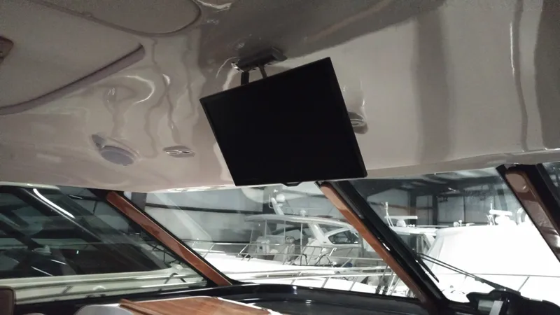 Slide: The Image of Interior of 2005 Tiara Yachts 4400 Sovran with ceiling-mounted TV and large windows. - 22