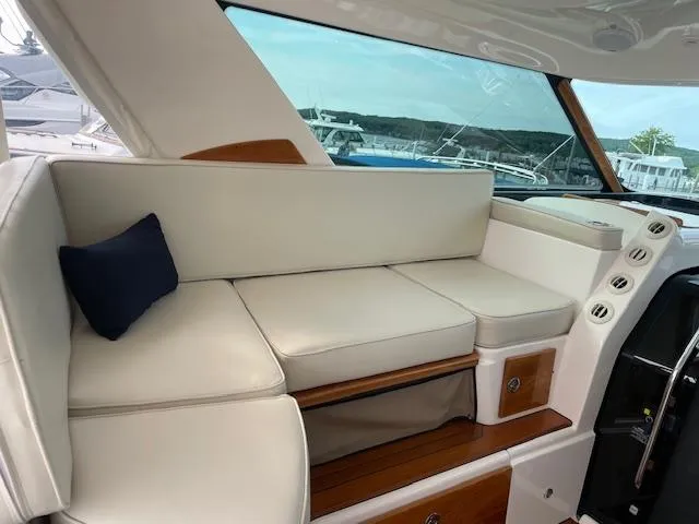Slide: The Image of 2005 Tiara Yachts 4400 Sovran interior with white seating and blue cushion. - 24