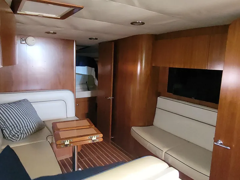 Slide: The Image of 2005 Tiara Yachts 4400 Sovran interior with wood paneling and comfortable seating. - 27