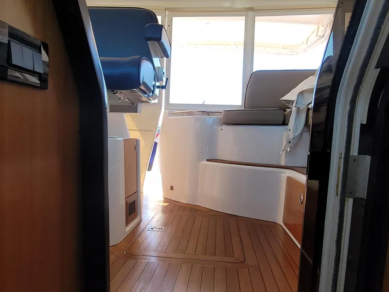 Slide: The Image of Interior view of 2005 Tiara Yachts 4400 Sovran with wooden flooring and seating area. - 28