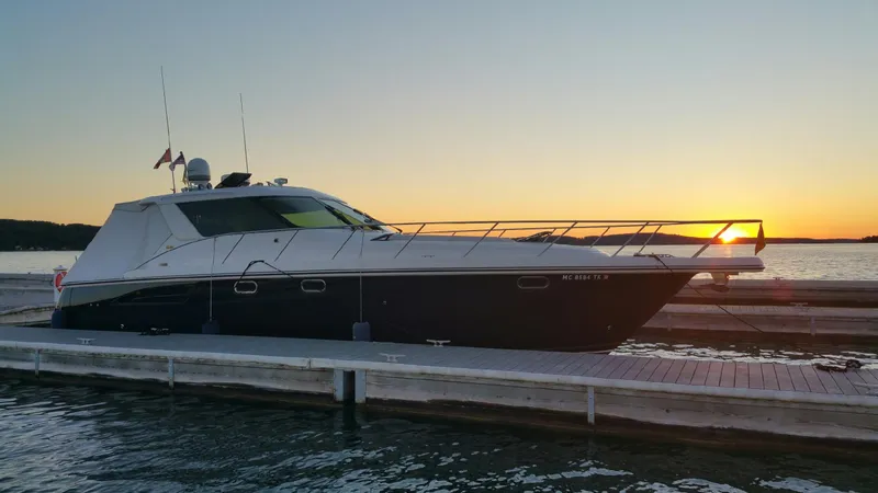 Slide: The Image of 2005 Tiara Yachts 4400 Sovran in scenic lake with rocky shoreline and trees. - 3