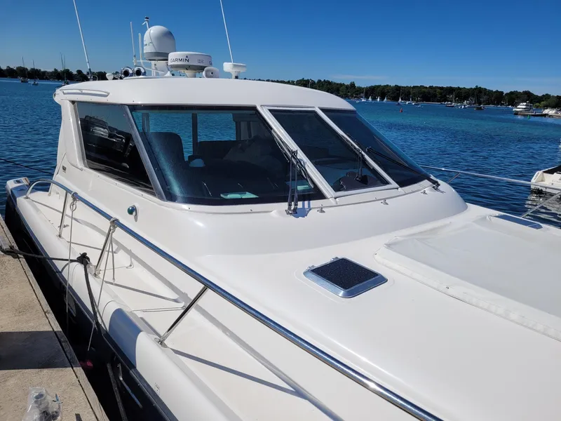 Slide: The Image of 2005 Tiara Yachts 4400 Sovran docked at sunset, serene waterfront view. - 4