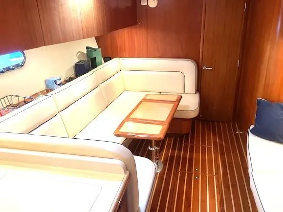 Slide: The Image of 2005 Tiara Yachts 4400 Sovran interior with elegant wood flooring and plush seating. - 41