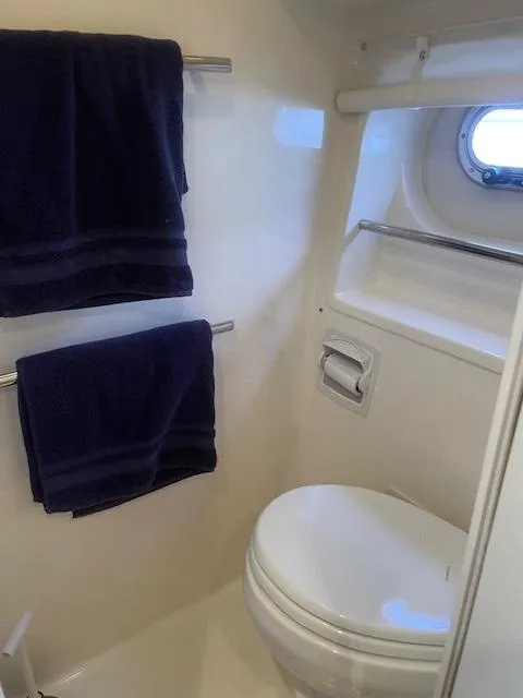 Slide: The Image of Bathroom interior of 2005 Tiara Yachts 4400 Sovran with towels and porthole. - 42