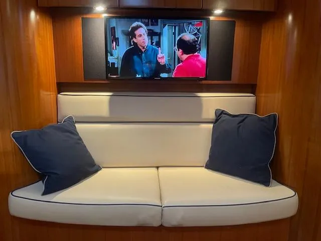 Slide: The Image of 2005 Tiara Yachts 4400 Sovran interior with TV and cushioned seating area. - 43