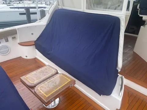 Slide: The Image of 2005 Tiara Yachts 4400 Sovran deck with covered seating and wooden flooring. - 47