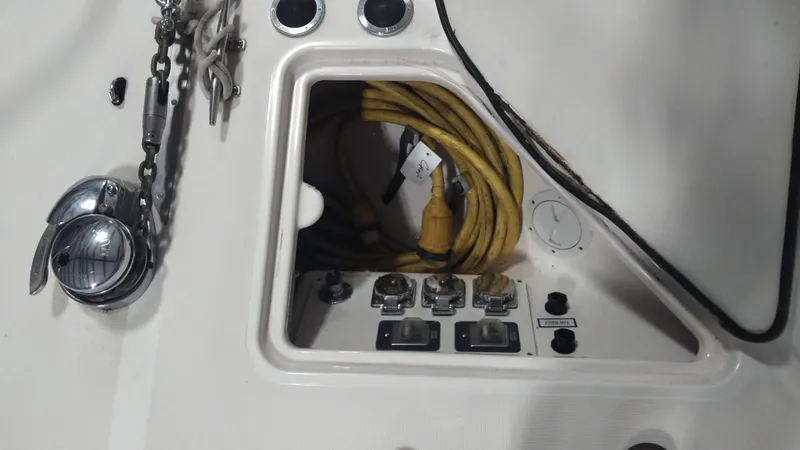 Slide: The Image of 2005 Tiara Yachts 4400 Sovran electrical panel with yellow cable and controls. - 58
