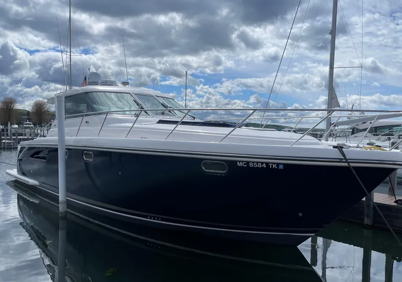 Slide: The Image of 2005 Tiara Yachts 4400 Sovran on calm water under clear blue sky. - 6