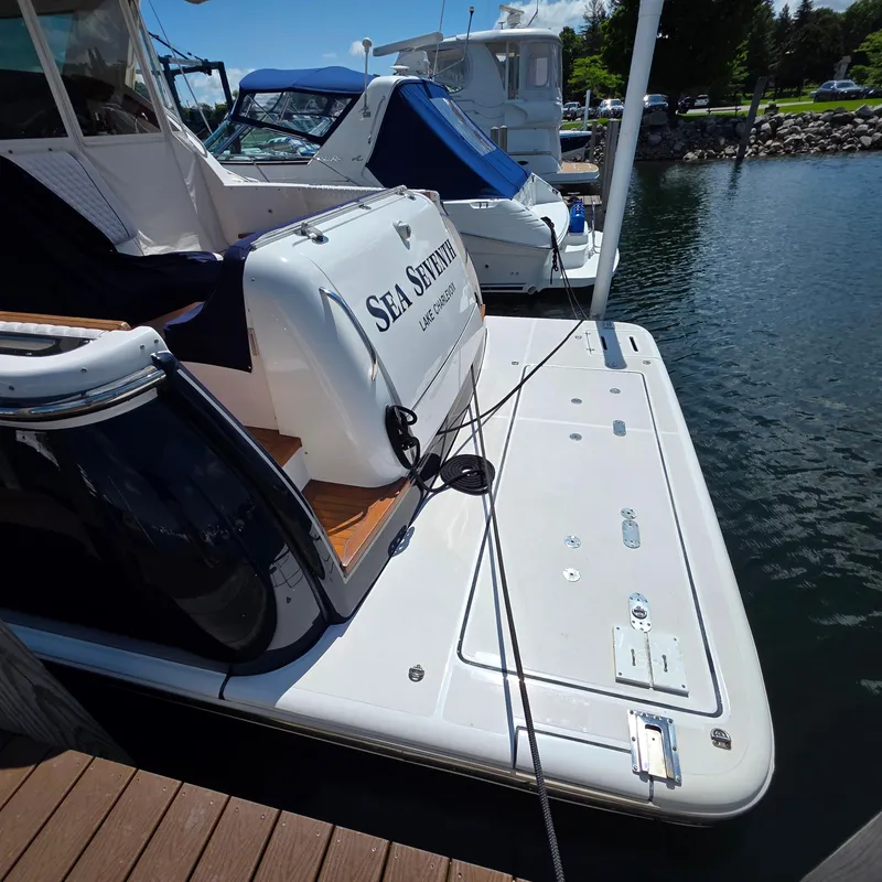 Slide: The Image of 2005 Tiara Yachts 4400 Sovran docked, featuring swim platform and "Sea Seventh" name. - 8