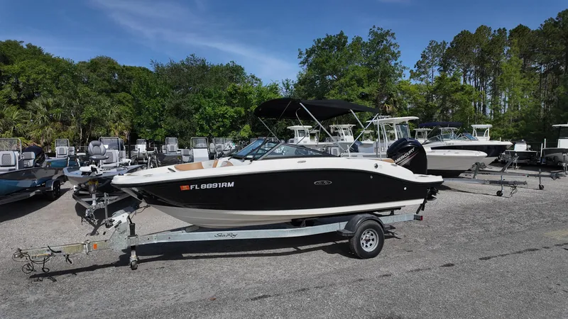 Slide: The Image of 2018 Sea Ray 190 Bow Rider on trailer in outdoor boat lot. - 11