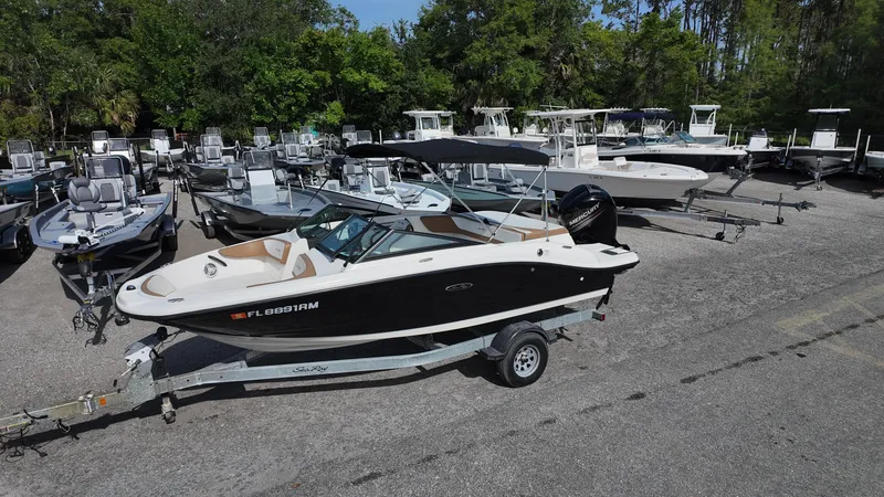 Slide: The Image of 2018 Sea Ray 190 Bow Rider on trailer in a boatyard. - 12