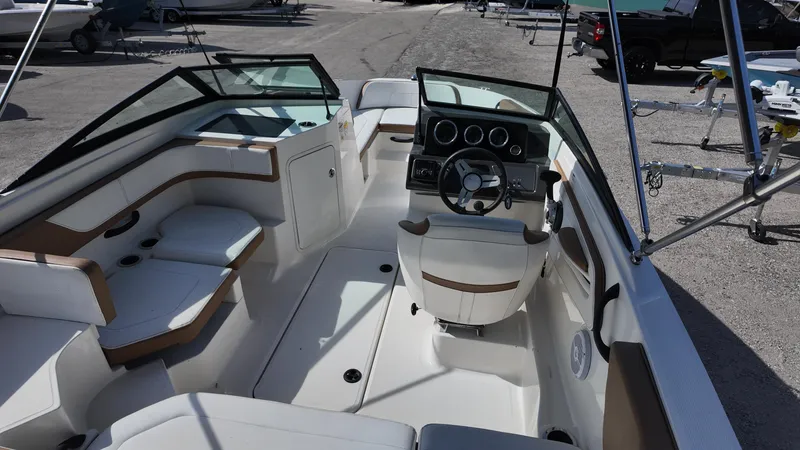 Slide: The Image of 2018 Sea Ray 190 Bow Rider interior with seating and steering console. - 13