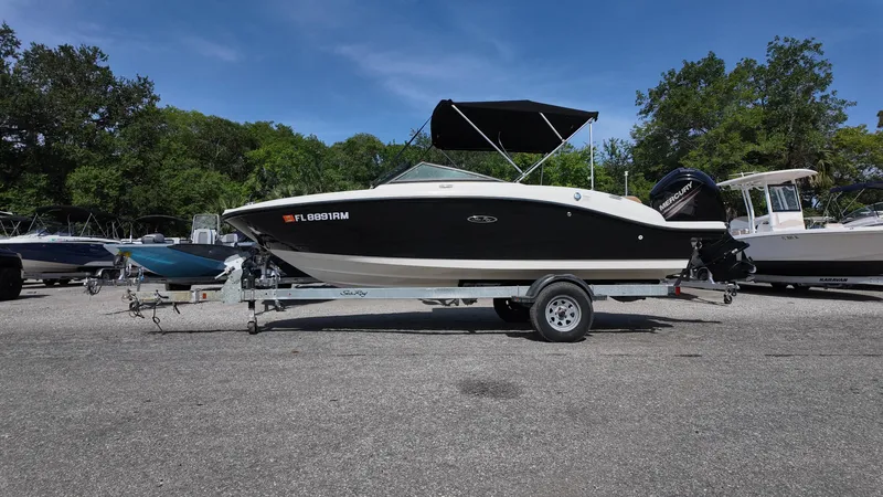Slide: The Image of 2018 Sea Ray 190 Bow Rider boat on trailer, parked outdoors. - 14