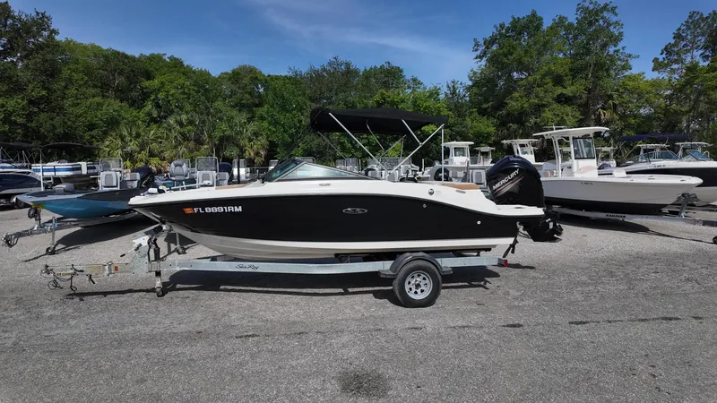 Slide: The Image of 2018 Sea Ray 190 Bow Rider boat on trailer in outdoor setting. - 16