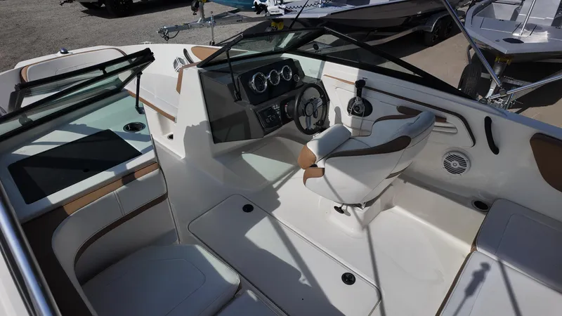 Slide: The Image of 2018 Sea Ray 190 Bow Rider interior with steering wheel and seating. - 17
