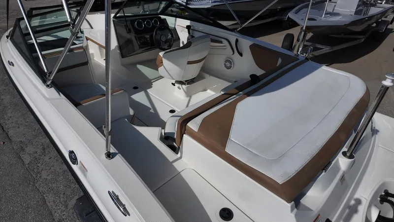 Slide: The Image of 2018 Sea Ray 190 Bow Rider interior with white and brown seating. - 22