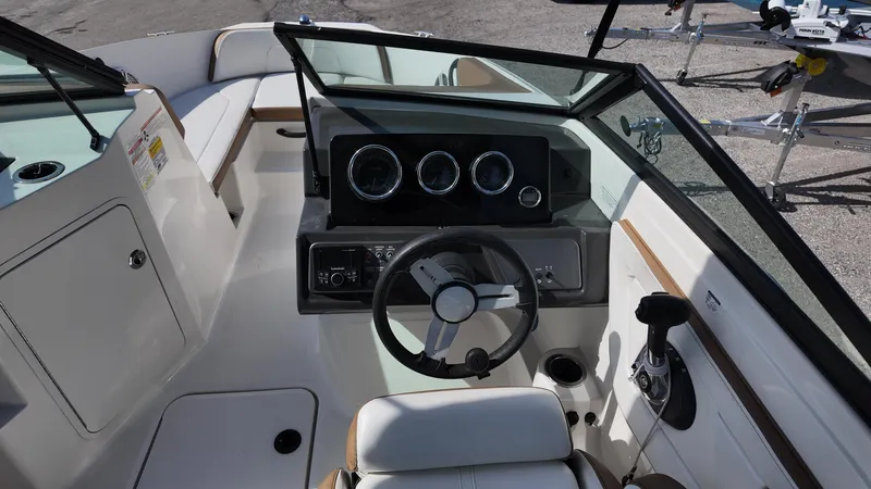 Slide: The Image of 2018 Sea Ray 190 Bow Rider boat interior with steering wheel and dashboard controls. - 23
