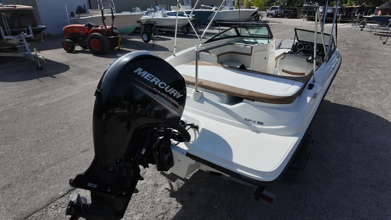 Slide: The Image of 2018 Sea Ray 190 Bow Rider with Mercury outboard engine in a boatyard. - 24