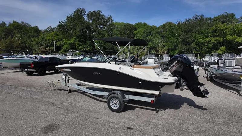 Slide: The Image of 2018 Sea Ray 190 Bow Rider boat on trailer in outdoor setting. - 27